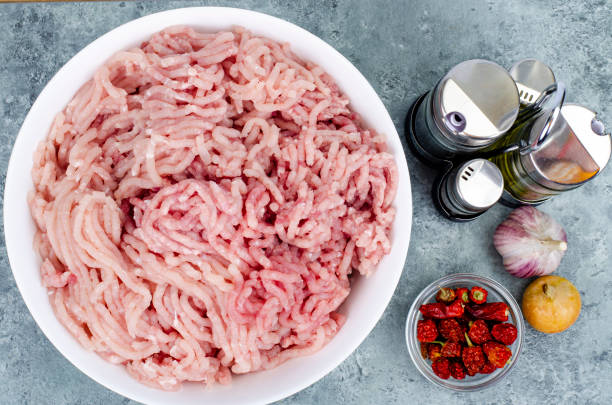 istock Plate with fresh minced meat, spices for cooking. Studio Photo 1354988675