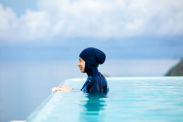 istock asian  muslim Woman in infinity pool 1354989762