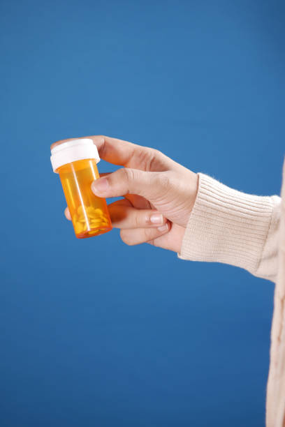 istock women man hand holding medicine pill container 1354994680