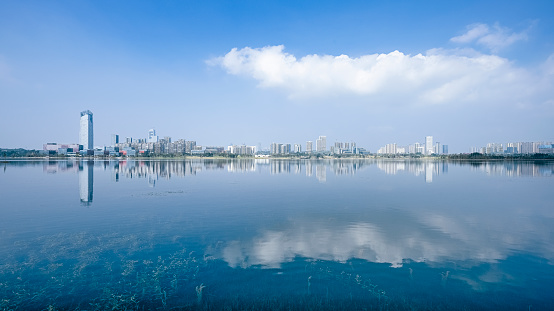 A prosperous financial city photographed by the river of Chengdu on a sunny and cloudy day