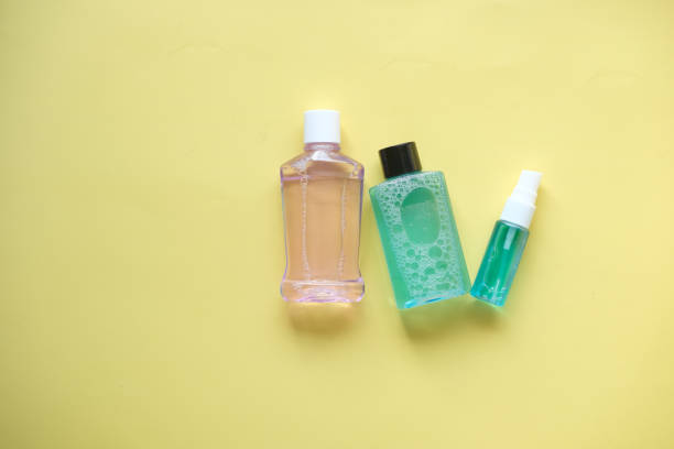 istock mouthwash liquid in a container on yelow background 1354997422