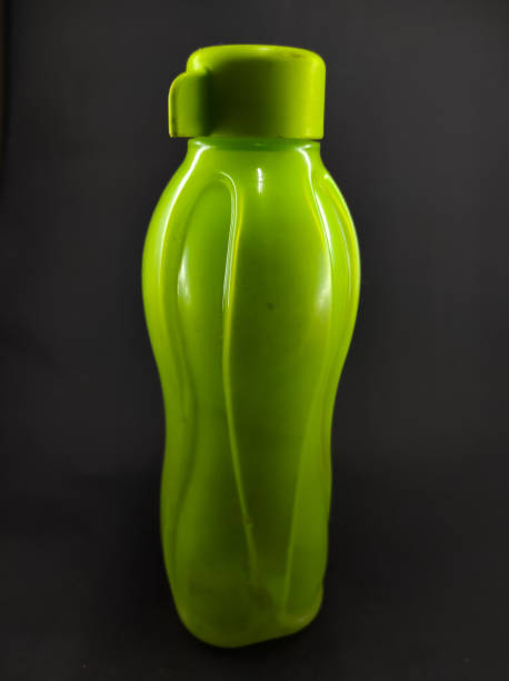 istock Green drinking bottle on black - stock photo 1354997446