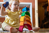 Baby girl in dress stacking rainbow arch block construction building ecological wooden toy tower