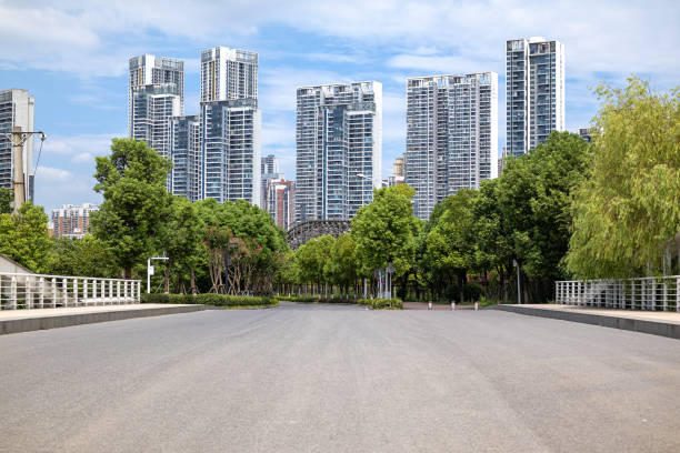istock Empty asphalt road with city skyline background 1355002313