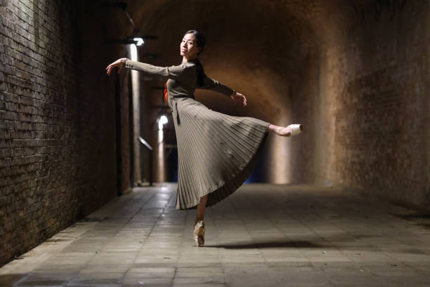 istock Beautiful woman dancing in tunnel 1355007904