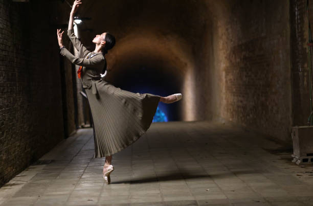 istock Beautiful woman dancing in tunnel 1355007962