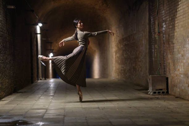 istock Beautiful woman dancing in tunnel 1355008020