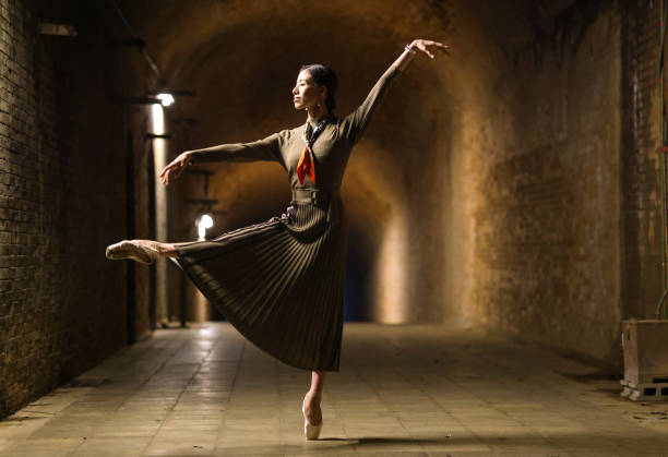 istock Beautiful woman dancing in tunnel 1355008097