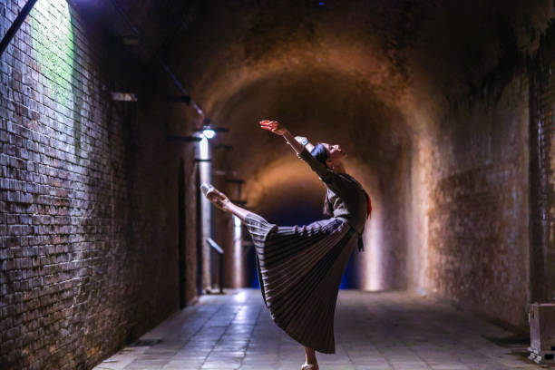 istock Beautiful woman dancing in tunnel 1355008743