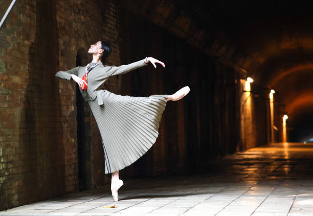 istock Beautiful woman dancing in tunnel 1355008750