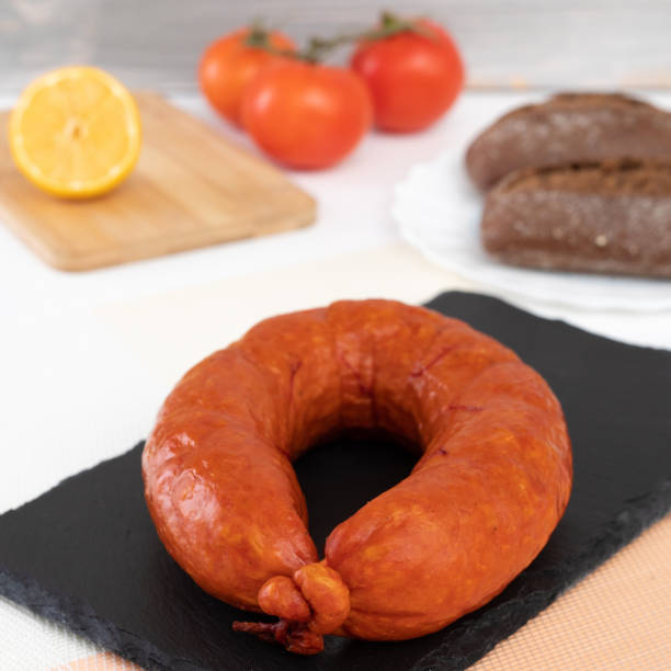 istock smoked sausages on a black background 1355011743