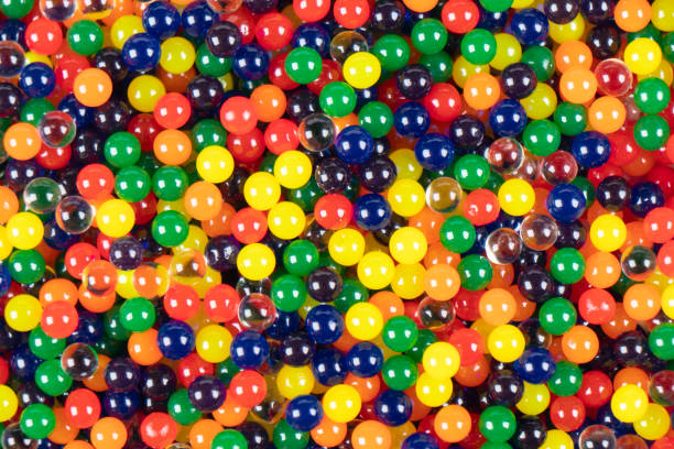istock Colorful plastic balls background texture. Macro shot abstract colorful spheres background. Multi colored balls pattern close up 1355014384