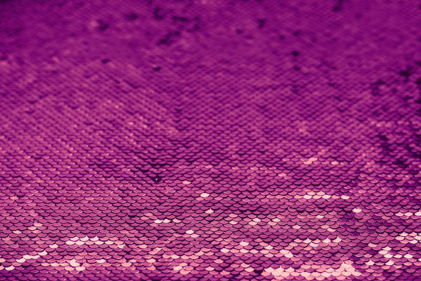 istock Shiny background with coral and violet sequins colors 2022. Abstract festive sparkling background 1355015901