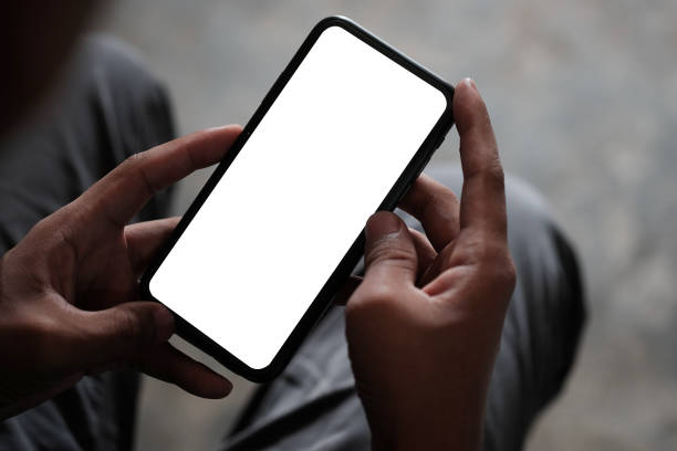 istock Over the shoulder view of man using smart phone. Blank screen for your information. 1355016655