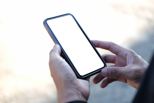 istock Close up view man holding mock up mobile phone with blank screen. 1355016836