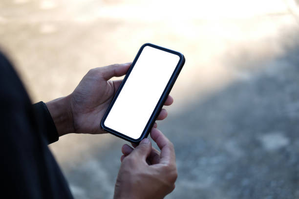 istock Close up view man holding mock up mobile phone with blank screen. 1355016876