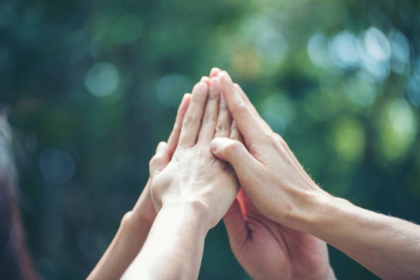 istock Group of teamwork high five team together hands raise up power partner. Diversity multiethnic group of businesspeople success team together. Collaborate Volunteer friendship mission Business partner 1355017147
