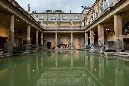 Bath , UK - Aug 1, 2017:  People visiting the Roman Baths  late in the day.