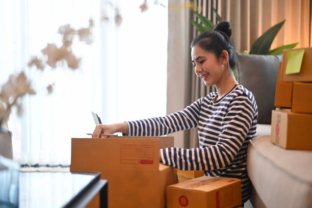istock Small business owner preparing parcel for delivery. Online selling or e-commerce concept. 1355024598