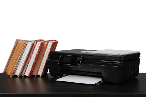 istock Working table with printer and stacked books on white abckground 1355026998