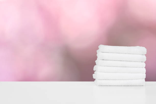 istock Stacked white spa towels on table against blurred background 1355027240