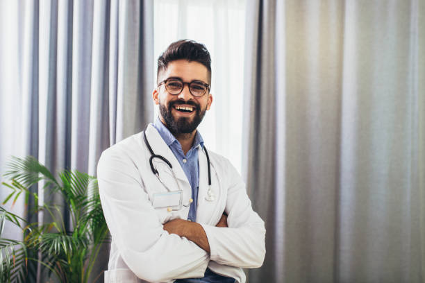 istock Doctor posing, looking at camera in his office 1355029665