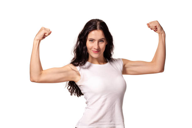 Happy young woman shows her muscles isolated on white background stock photo