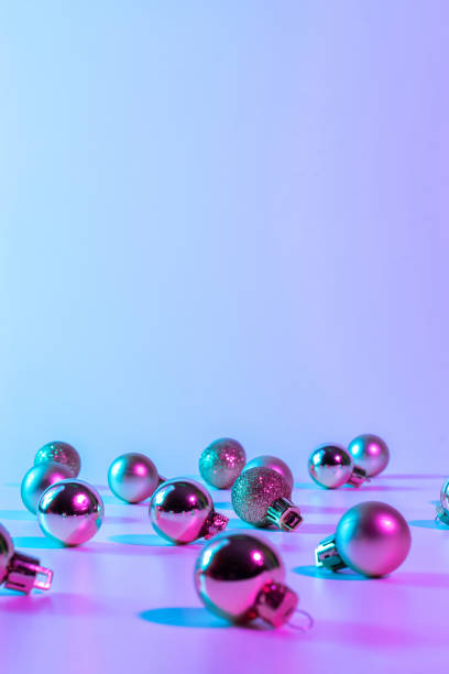 istock Christmas balls pattern neon background. Xmas bauble on abstract holiday winter gradient backdrop. Happy new year copy space. 1355030890