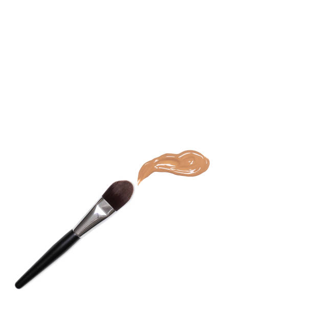 istock Make-up brush with smeared makeup foundation sample on white background top view 1355031031