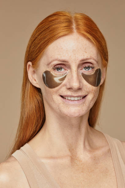 istock Red Haired Woman Using Beauty Patches 1355031274