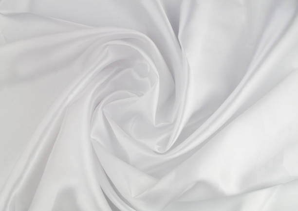 istock White satin or silk fabric as background. 1355033903