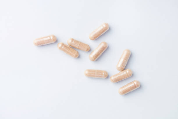 istock Hop Extract Capsules. Bright paper background. Top view. Close up. 1355034143