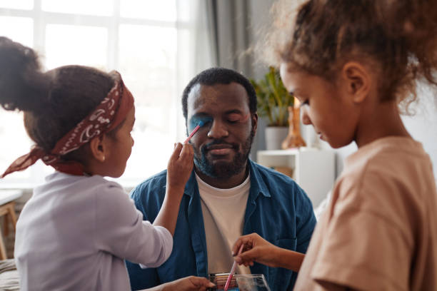 istock Girls doing Fathers Makeup 1355034416