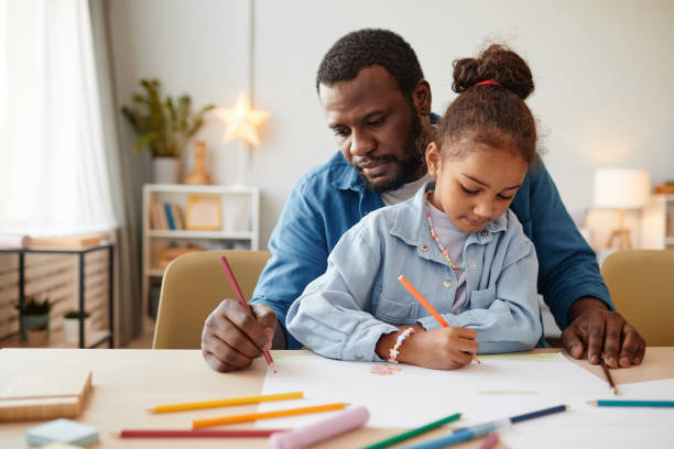 istock Father and Daughter Drawing 1355034481