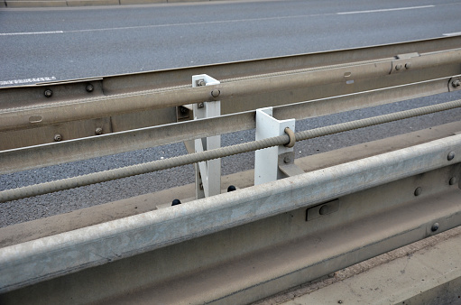 connection of metal and concrete highway barriers with screws. reinforcement with metal struts and tensioned bars in places where there is not enough space between the lanes. noise barrier