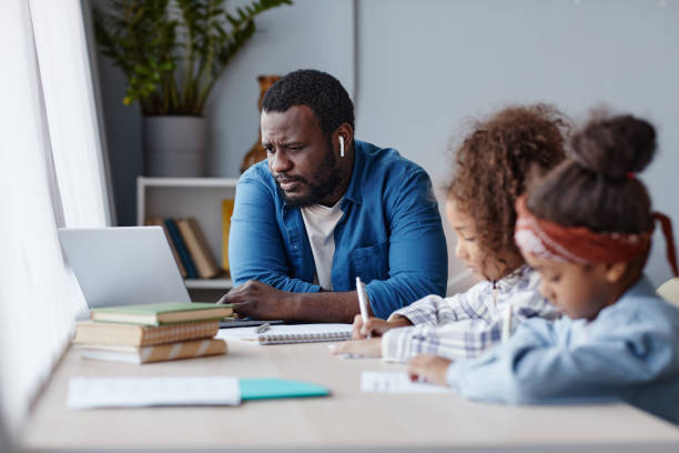 istock Father Helping Kids with Online School 1355035137