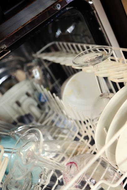 istock Dirty dishes in dishwasher 1355035216