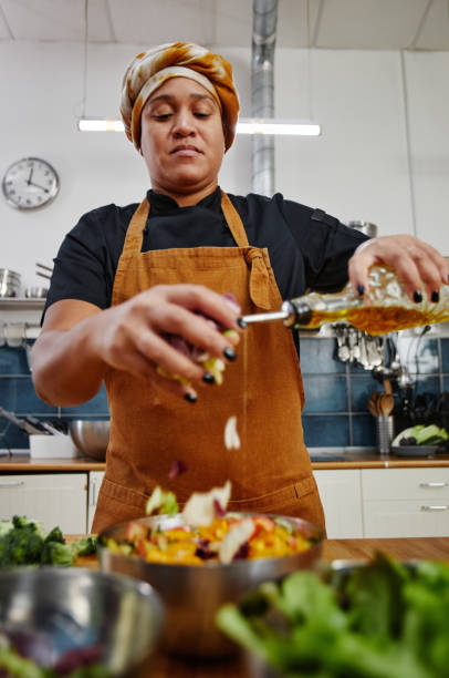 istock Woman Making Salad in Kitchen 1355035462