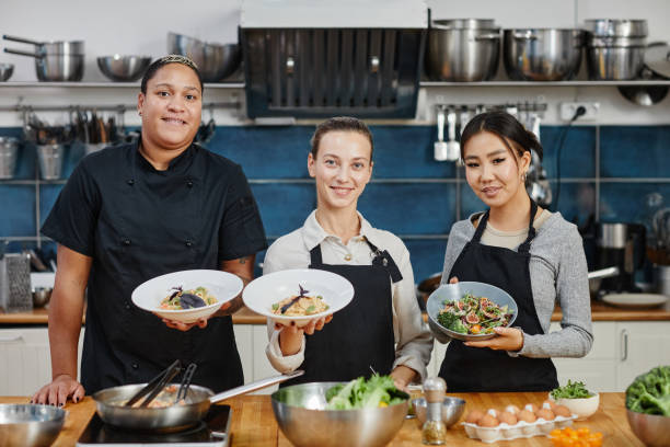 istock Women Presenting Gourmet Dishes 1355035697