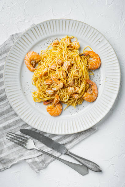 istock Pesto prawn pasta , on plate, on white stone  surface, top view flat lay 1355037784