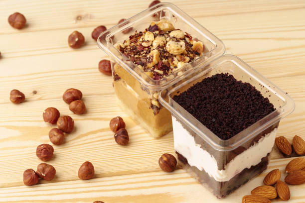 istock Creamy dessert in a plastic box on wooden table 1355037875