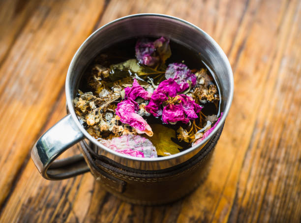 istock Touristic mug with herbal tea on the rustic background. Selective focus. 1355038089