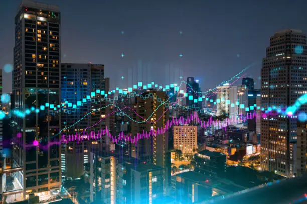 Photo of FOREX graph hologram, aerial night panoramic cityscape of Bangkok, the developed location for stock market researchers in Asia. The concept of fundamental analysis. Double exposure.