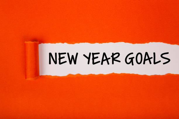 istock Torn Paper With New Year Goals On White Background 1355038878