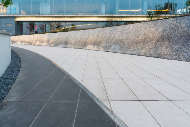 istock empty ground floor in front of modern office building exterior. 1355040188