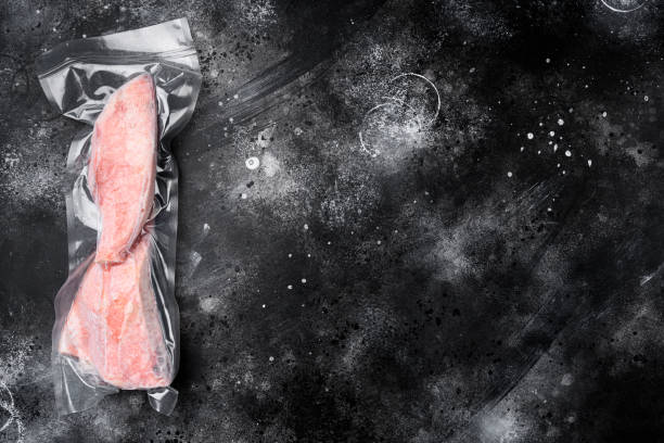 istock Red perch frozen pack fish meat, on black dark stone table background, top view flat lay, with copy space for text 1355041412