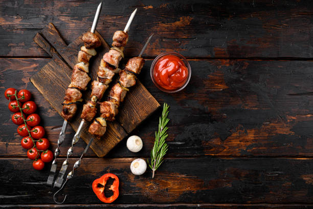 Kebabs grilled meat skewers, shish kebab, on old dark  wooden table background, top view flat lay, with copy space for text Kebabs grilled meat skewers, shish kebab set, on old dark  wooden table background, top view flat lay, with copy space for text kebab stock pictures, royalty-free photos & images