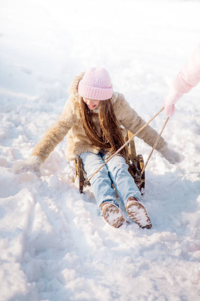 istock Mom sleds her funny daughter 12 years 1355042016