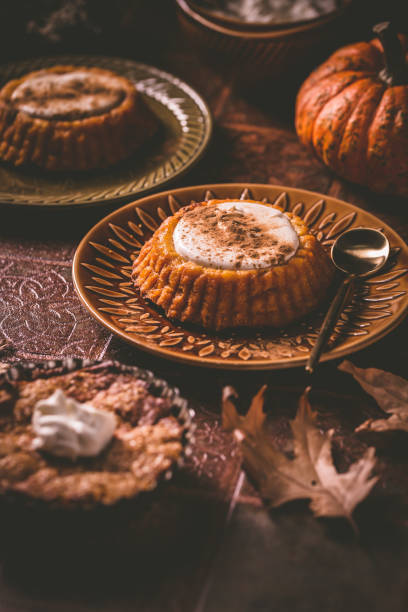 istock Homemade small pumpkin pies with icing for Thanksgiving 1355042053