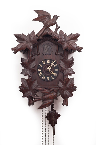 Antique wall wooden clock with hands of the clock and gold pendulum